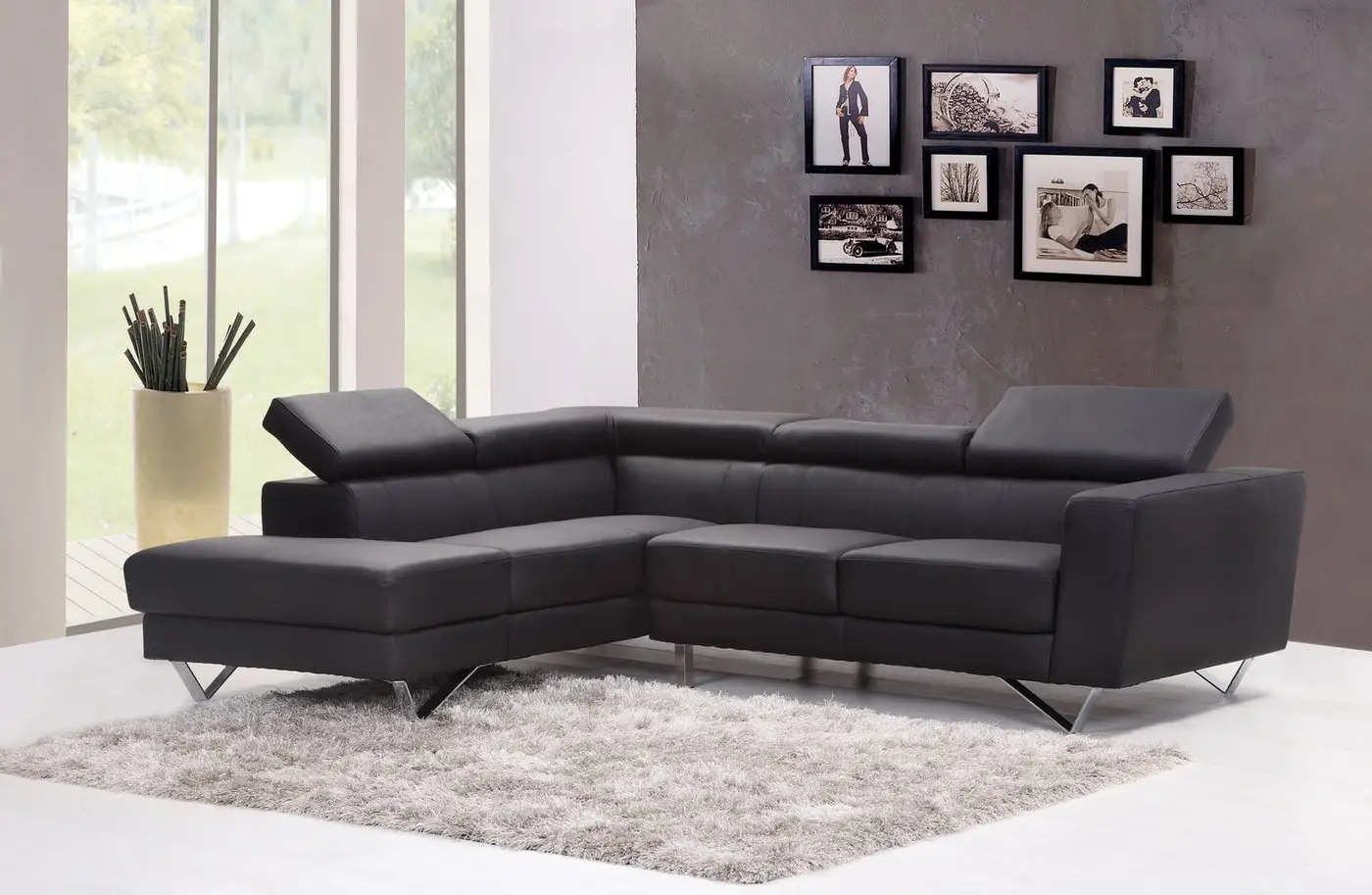 A dark sectional sofa with a smooth, even surface beside a window