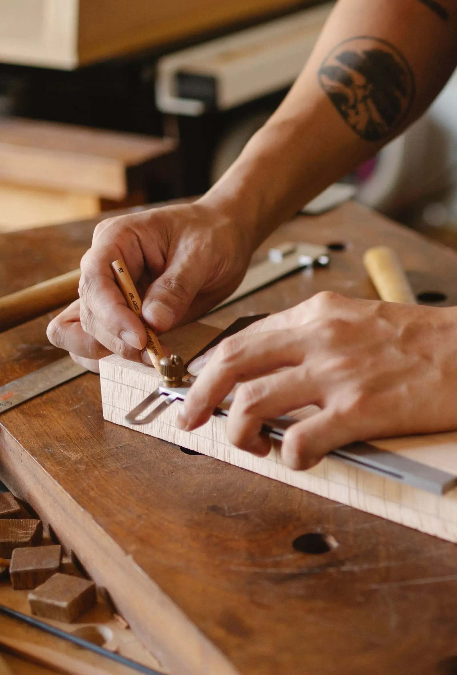 A marking gauge setting a line on the edge of a timber block